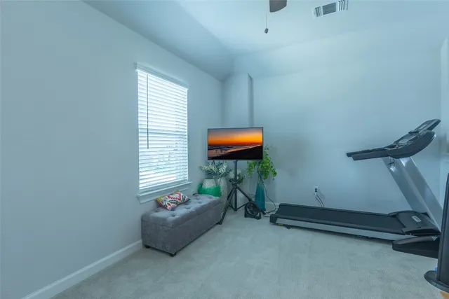 a bedroom with a bed and a dresser in it