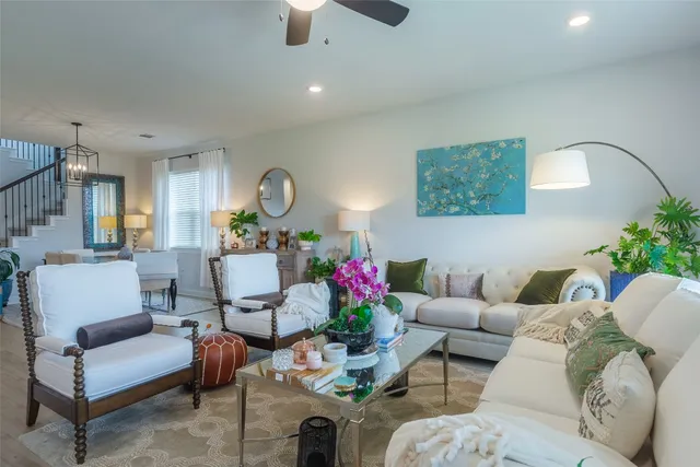 a living room with furniture and a chandelier