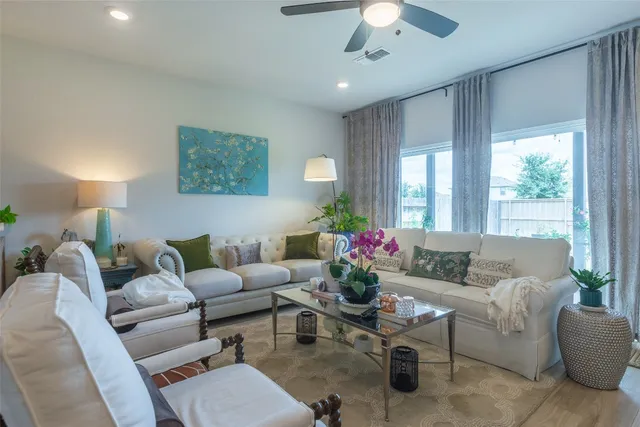 a living room with furniture and a large window