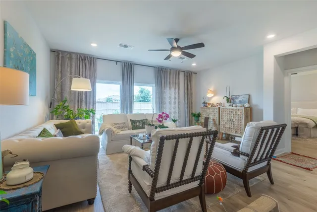 a living room with furniture and a large window