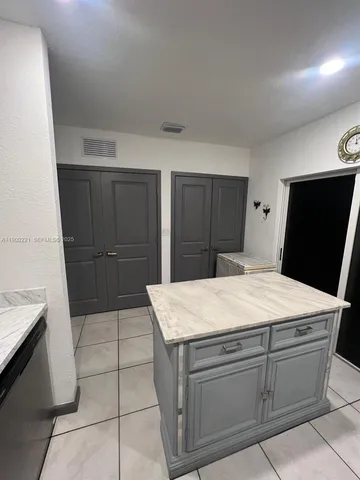 a kitchen with a stove a refrigerator and a sink