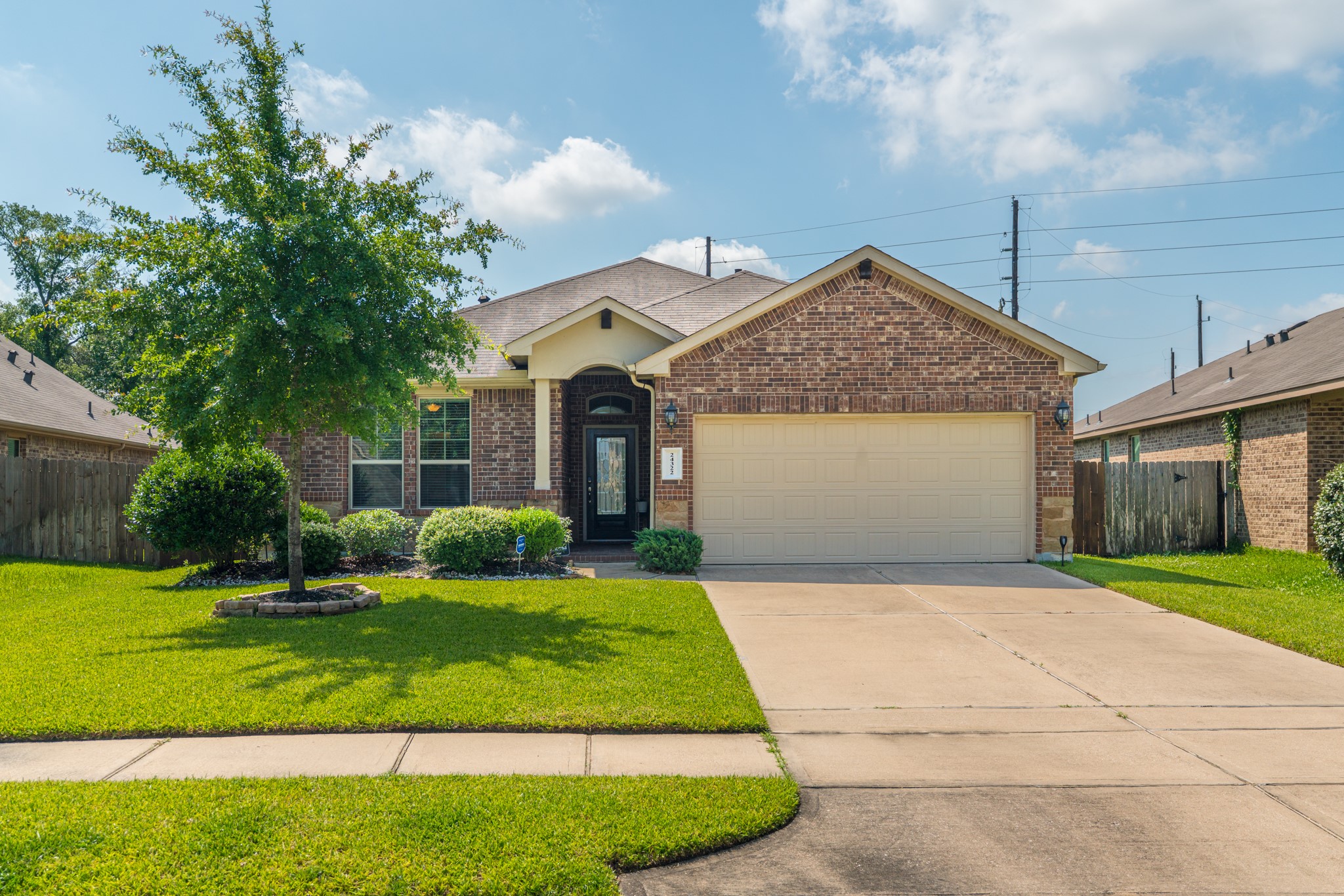 24322 North Newcastle Bay Trail Spring, TX 77389 - Photo 7 of 50 a front view of a house with a yard and garage
