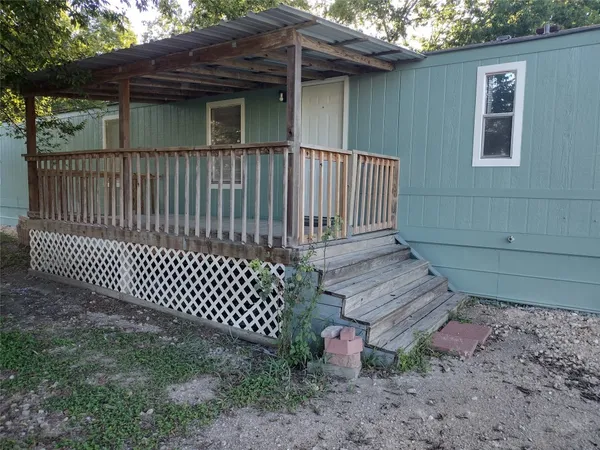 a view of a wooden house with a yard