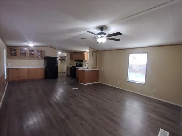 a view of a kitchen with a stove cabinets and wooden floor