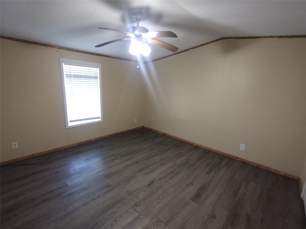 40 Church Street Maxwell, TX 78656 - Photo 7 of 12 an empty room with wooden floor chandelier fan and windows