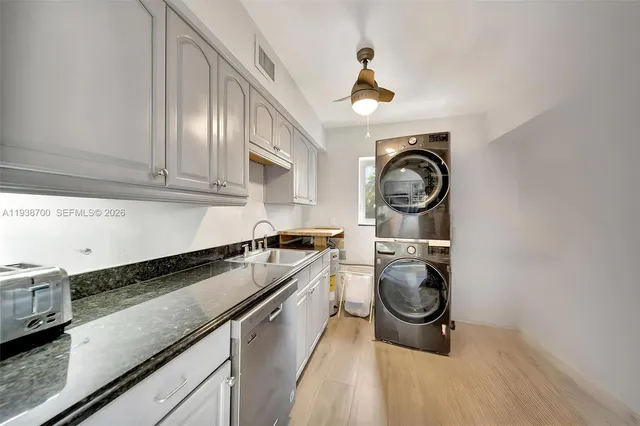 a kitchen with stainless steel appliances a refrigerator sink and microwave