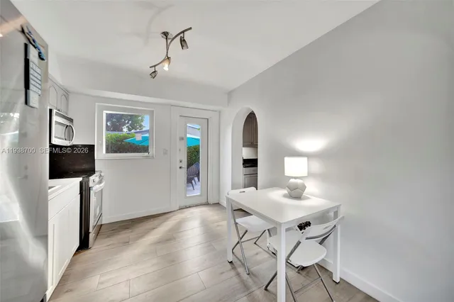 a kitchen that has a lot of cabinets in it and appliances