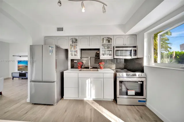 a utility room with sink dryer and washer