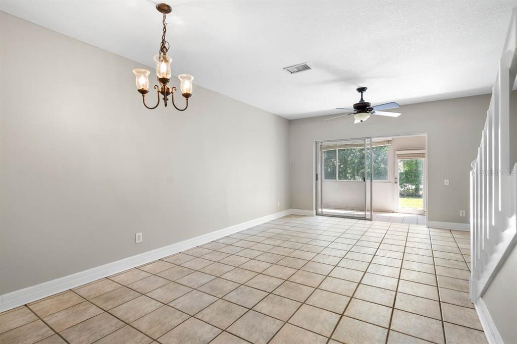 273 Countryside Key Boulevard Oldsmar, FL 34677 - Photo 13 of 32 a view of empty room with wooden floor and fan