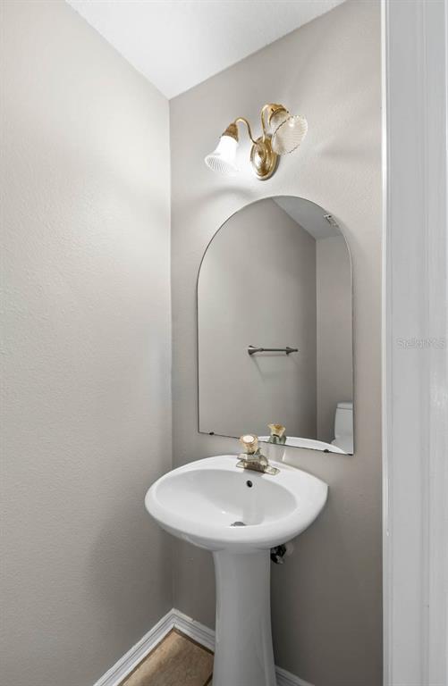 273 Countryside Key Boulevard Oldsmar, FL 34677 - Photo 14 of 32 a bathroom with a sink and a mirror