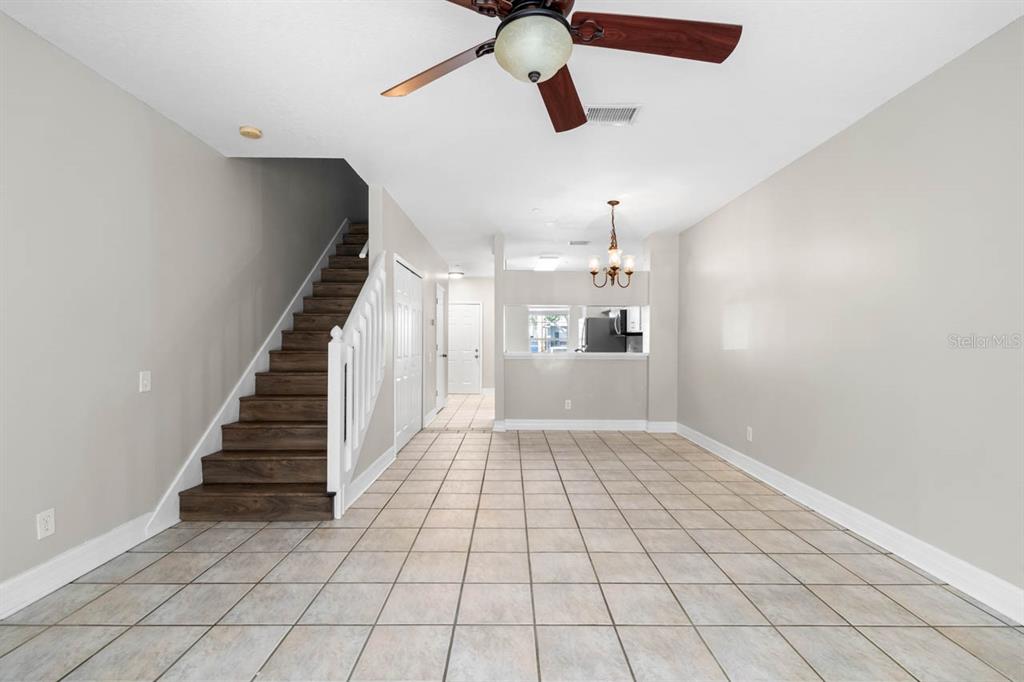 273 Countryside Key Boulevard Oldsmar, FL 34677 - Photo 19 of 32 wooden floor in an empty room with a chandelier fan