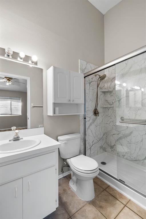 273 Countryside Key Boulevard Oldsmar, FL 34677 - Photo 20 of 32 a bathroom with a white sink a toilet and shower