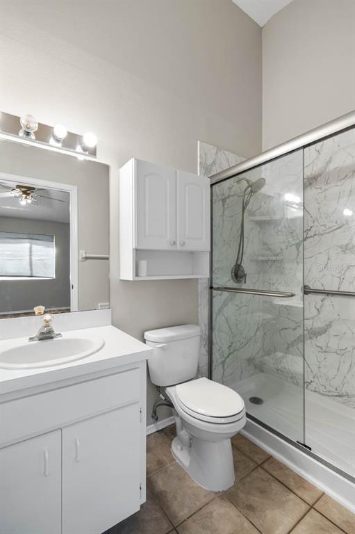 273 Countryside Key Boulevard Oldsmar, FL 34677 - Photo 21 of 32 a bathroom with a white sink a toilet and shower