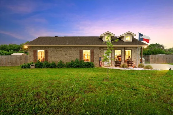 a front view of a house with swimming pool having outdoor seating