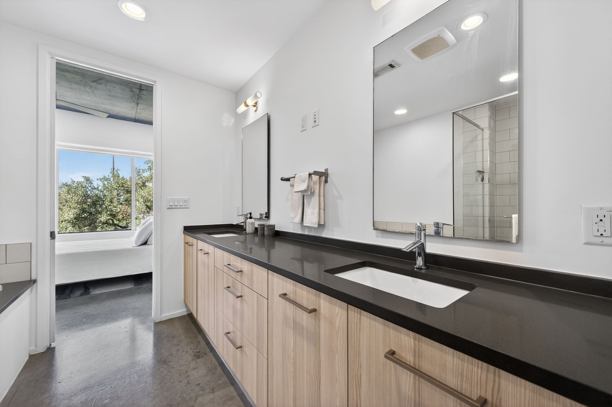 2301 South 5th Street, Unit 25 Austin, TX 78704 - Photo 19 of 35 Bathroom with double vanity, a stall shower, recessed lighting, and finished concrete floors