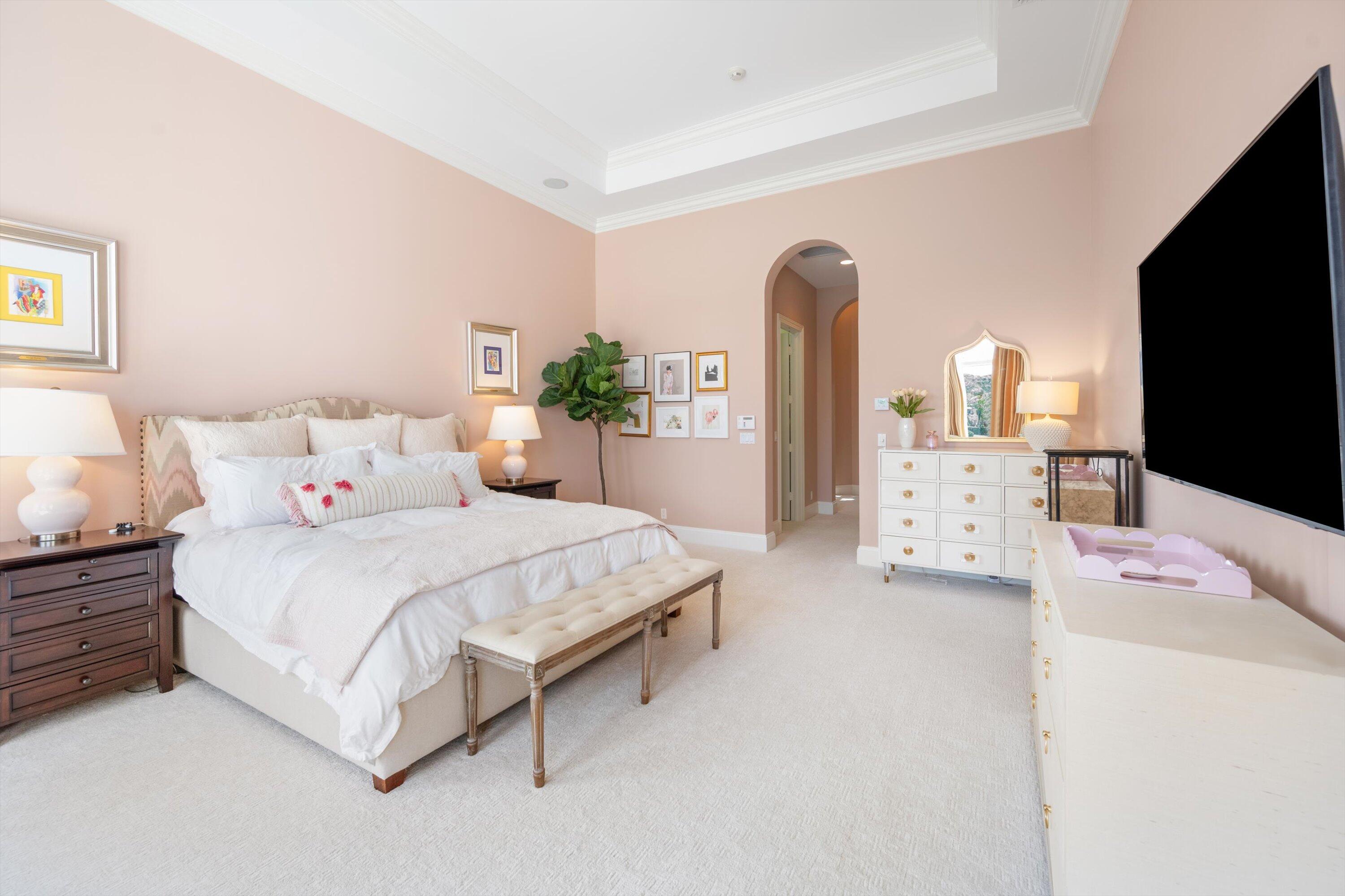 115 Echo Lane Jupiter, FL 33458 - Photo 20 of 35 a spacious bedroom with a bed and a flat screen tv