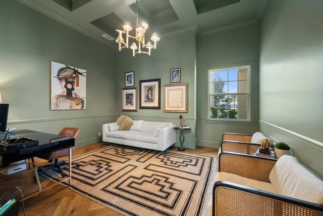 a living room with furniture and a chandelier