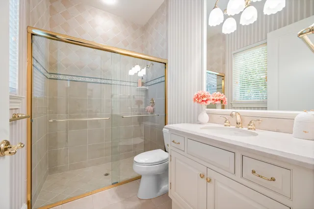 a bathroom with a sink toilet and shower