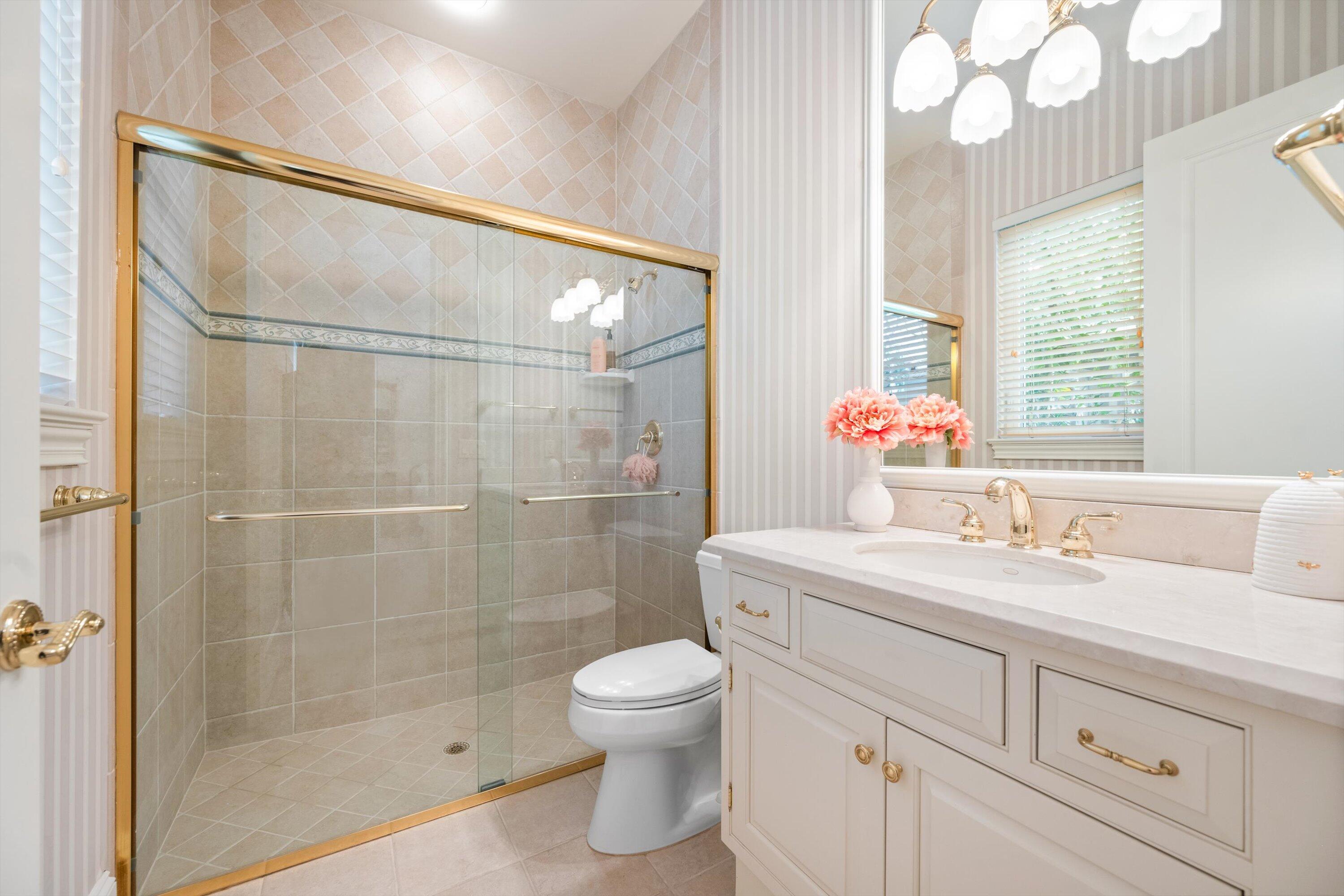 115 Echo Lane Jupiter, FL 33458 - Photo 25 of 35 a bathroom with a sink toilet and shower