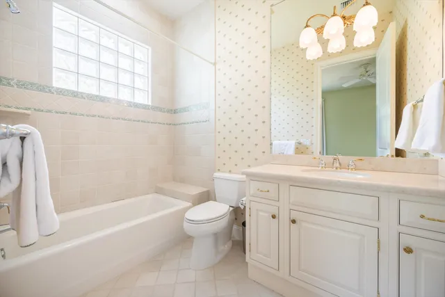 a bathroom with a bathtub a sink and a large mirror