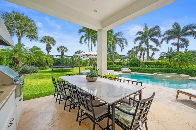 a view of a yard with a table and chairs