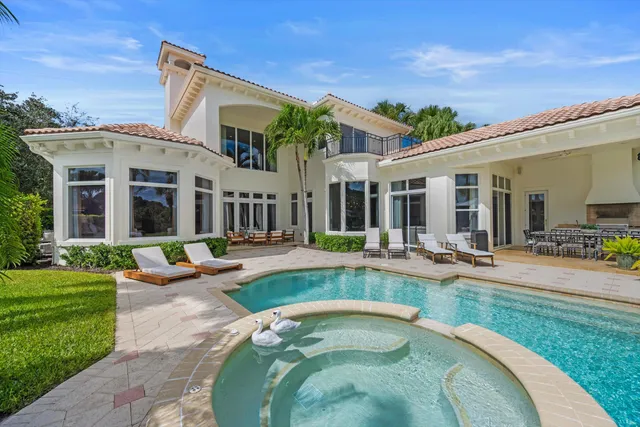 a view of a house with swimming pool and porch