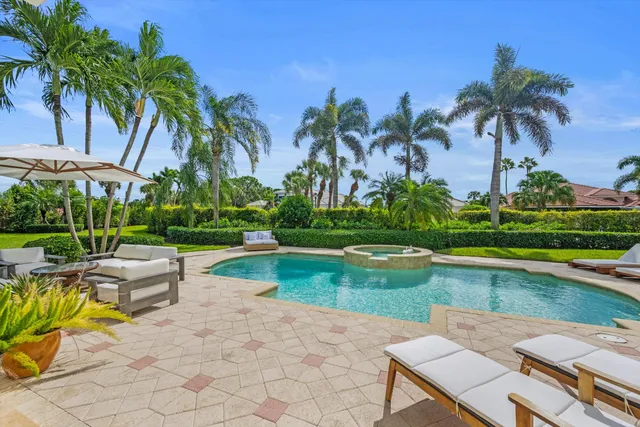 a view of swimming pool with outdoor seating and plants