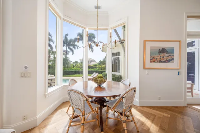 a view of a dining room with furniture large windows and wooden floor