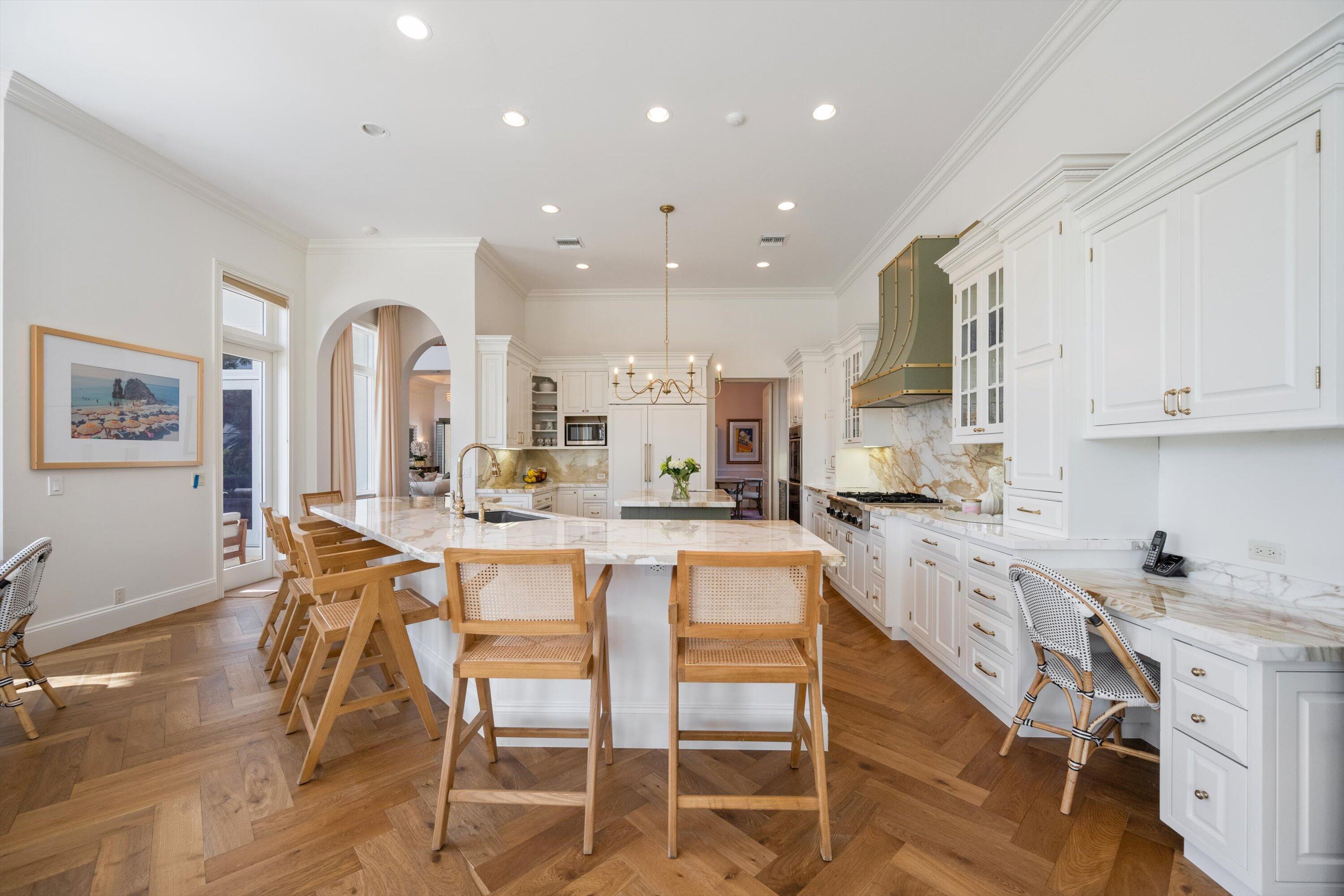 115 Echo Lane Jupiter, FL 33458 - Photo 10 of 35 a large kitchen with a table and chairs in it