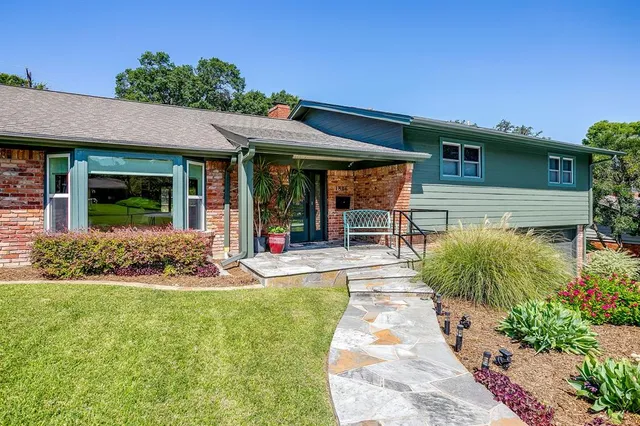 a front view of a house with garden