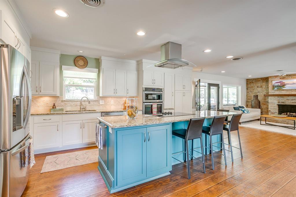 1816 Granada Road Fort Worth, TX 76116 - Photo 12 of 40 a kitchen with cabinets and chairs