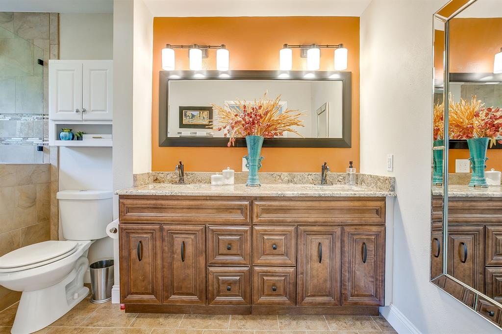 1816 Granada Road Fort Worth, TX 76116 - Photo 22 of 40 a bathroom with a granite countertop toilet sink and mirror