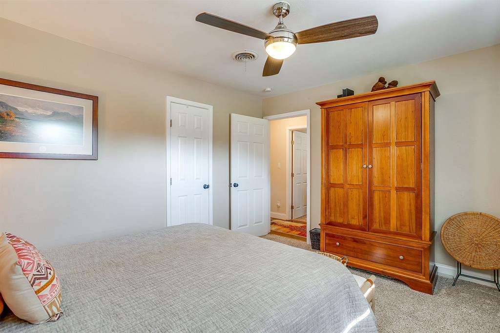 1816 Granada Road Fort Worth, TX 76116 - Photo 25 of 40 a bedroom with a bed and a chandelier