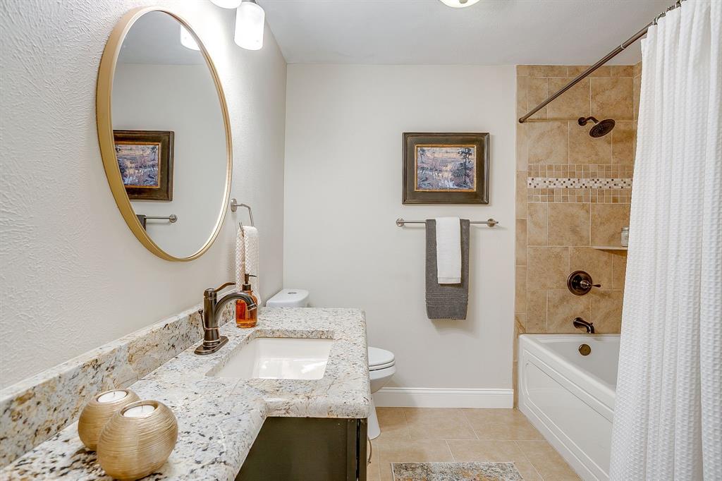 1816 Granada Road Fort Worth, TX 76116 - Photo 27 of 40 a bathroom with a granite countertop sink mirror and bathtub
