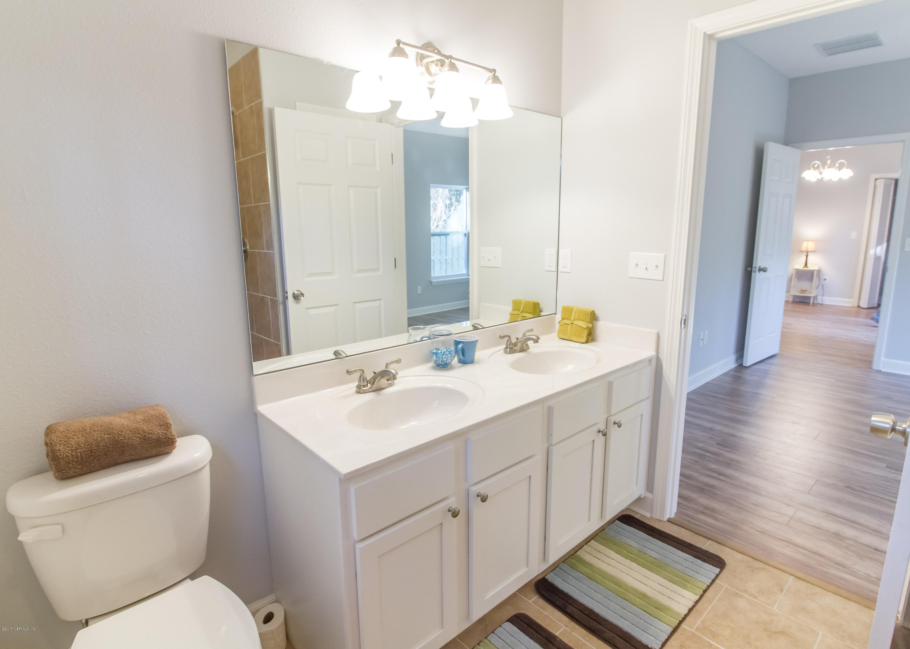 109 Jasmine Road St. Augustine, FL 32086 - Photo 11 of 36 a bathroom with a toilet sink and mirror