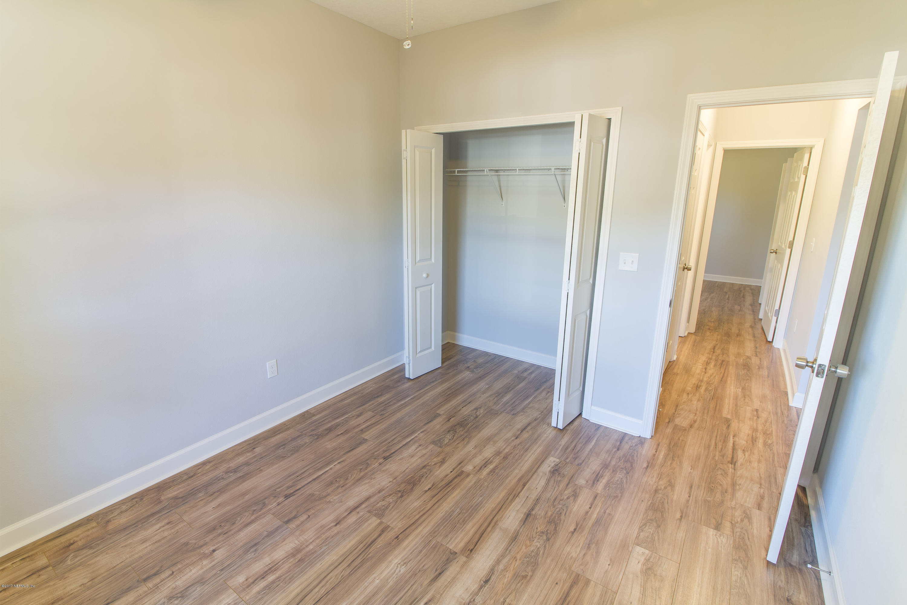 109 Jasmine Road St. Augustine, FL 32086 - Photo 24 of 36 an empty room with wooden floor and entrance