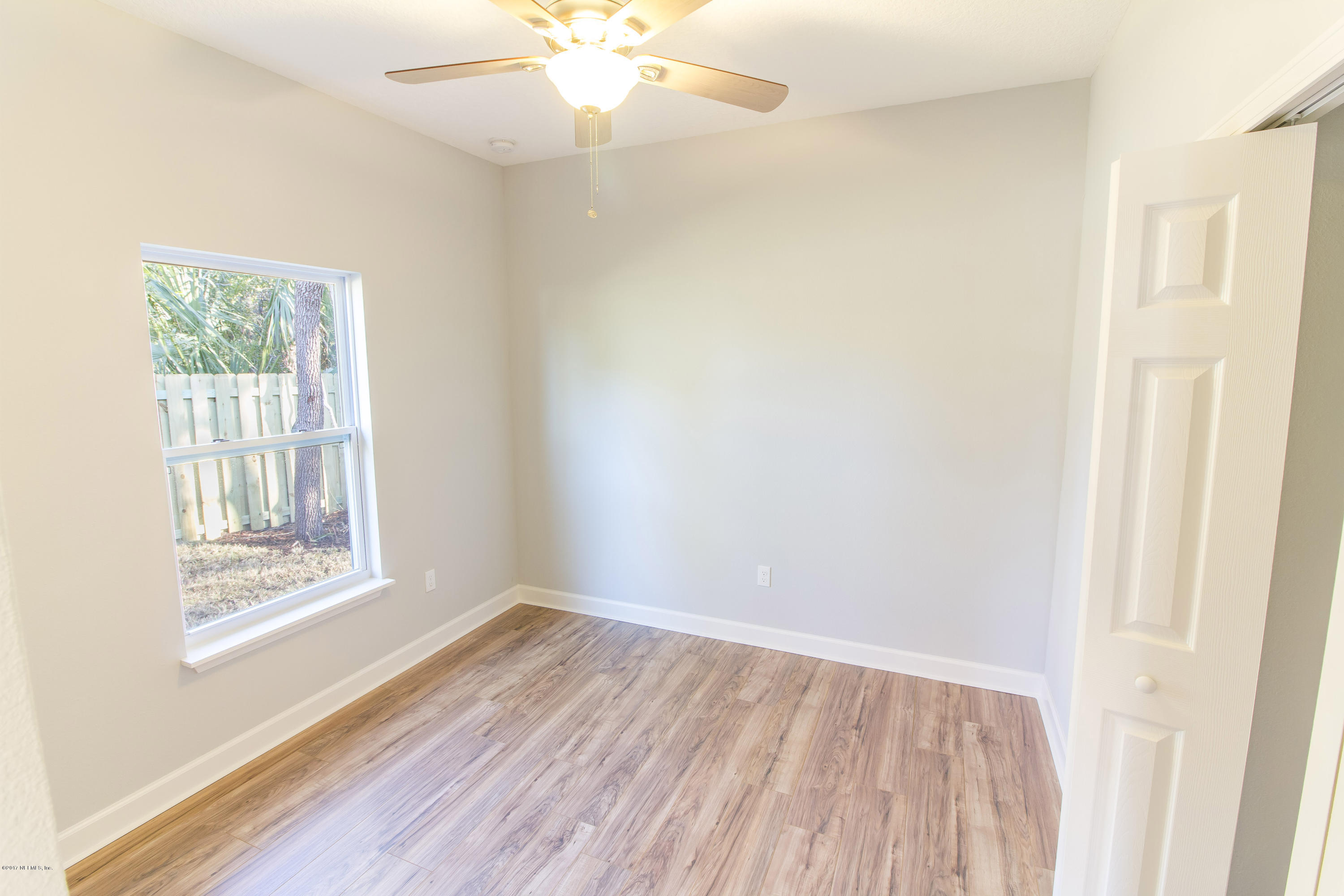109 Jasmine Road St. Augustine, FL 32086 - Photo 27 of 36 a view of an empty room with wooden floor and a window