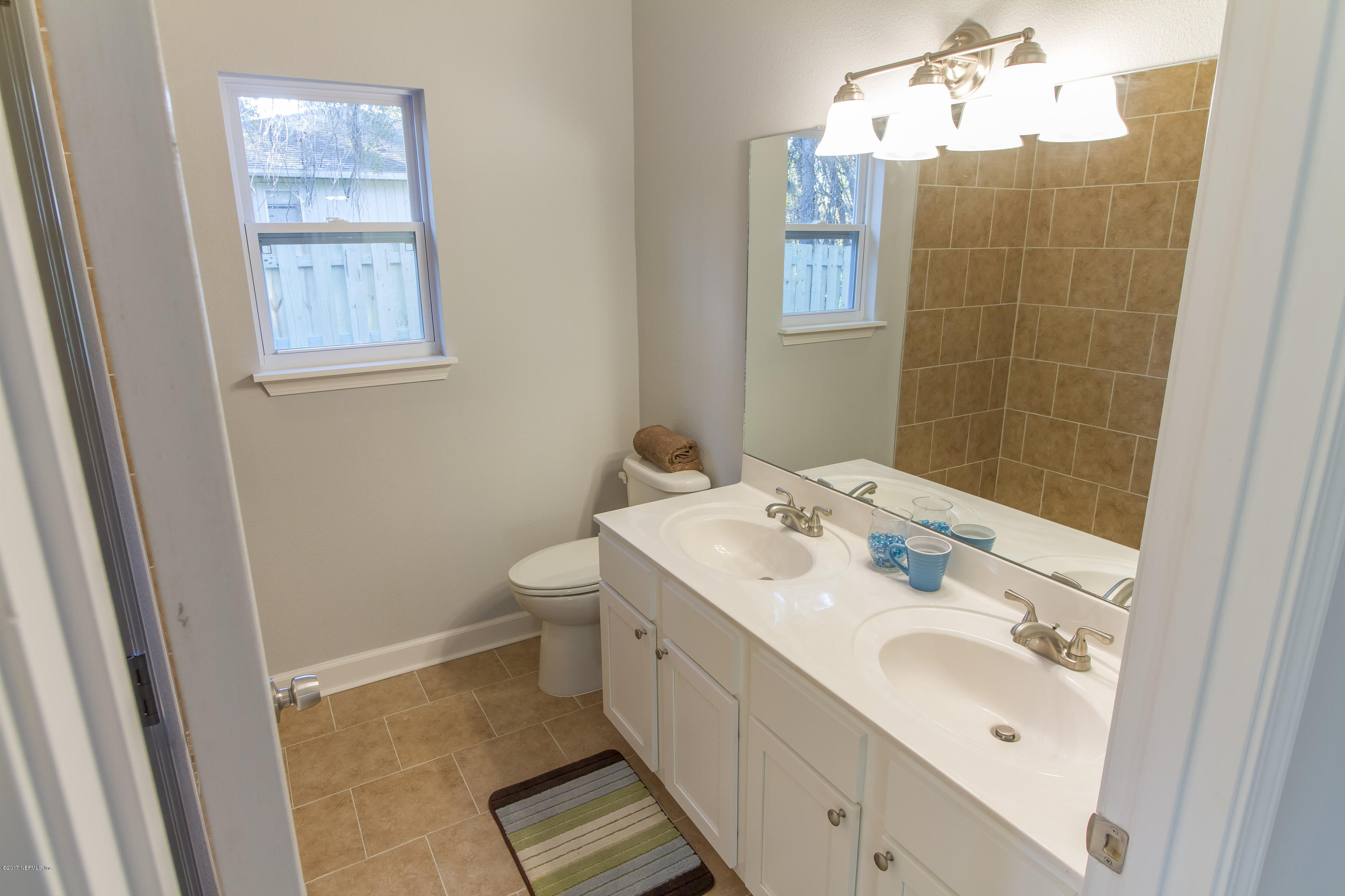 109 Jasmine Road St. Augustine, FL 32086 - Photo 10 of 36 a spacious bathroom with a double vanity sink mirror and toilet