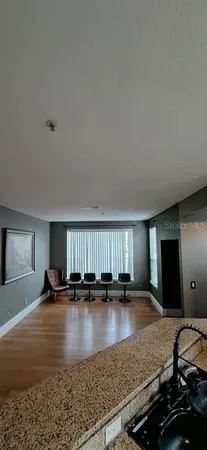a view of an empty room with window and a ceiling fan