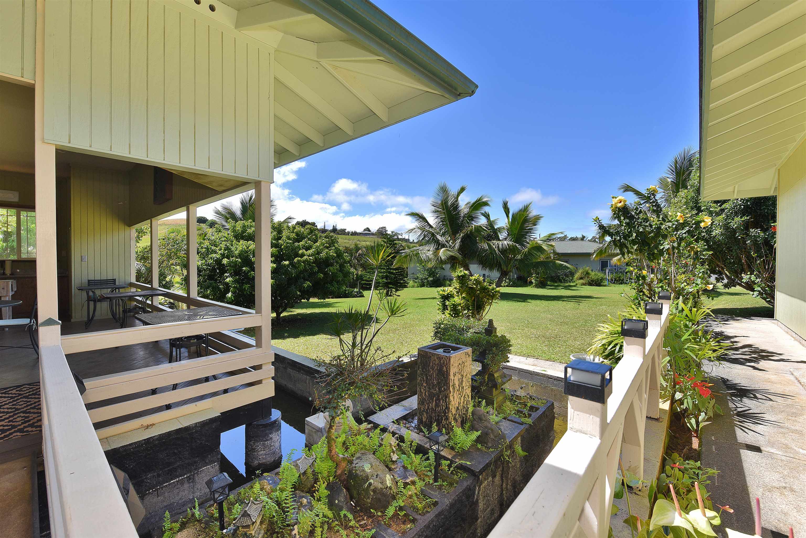 1525 Kaupakalua Road Haiku, HI 96708 - Photo 22 of 47 a view of a swimming pool and lounge chairs in patio