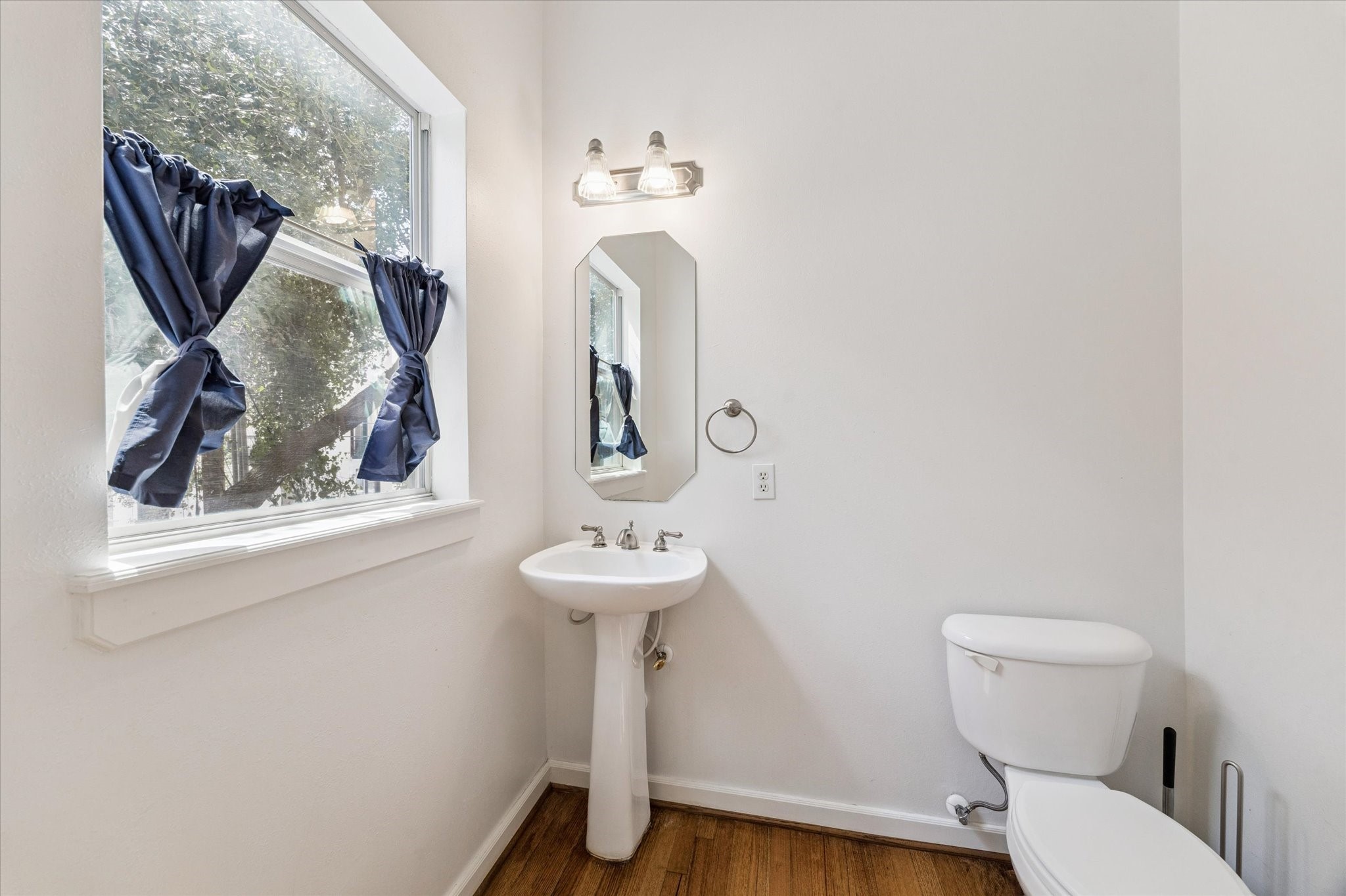 5736 Kansas Street, Unit B Houston, TX 77007 - Photo 11 of 28 a bathroom with a toilet sink and mirror
