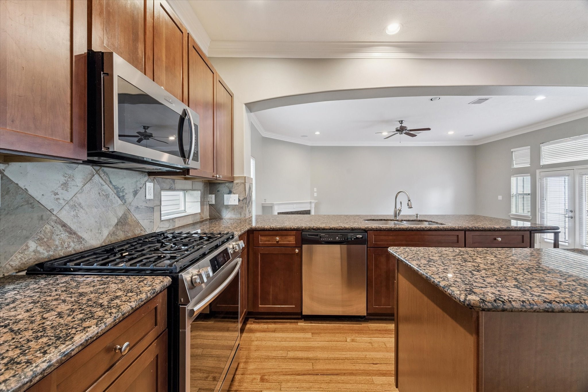 5736 Kansas Street, Unit B Houston, TX 77007 - Photo 13 of 28 a kitchen with stainless steel appliances granite countertop a stove and a microwave