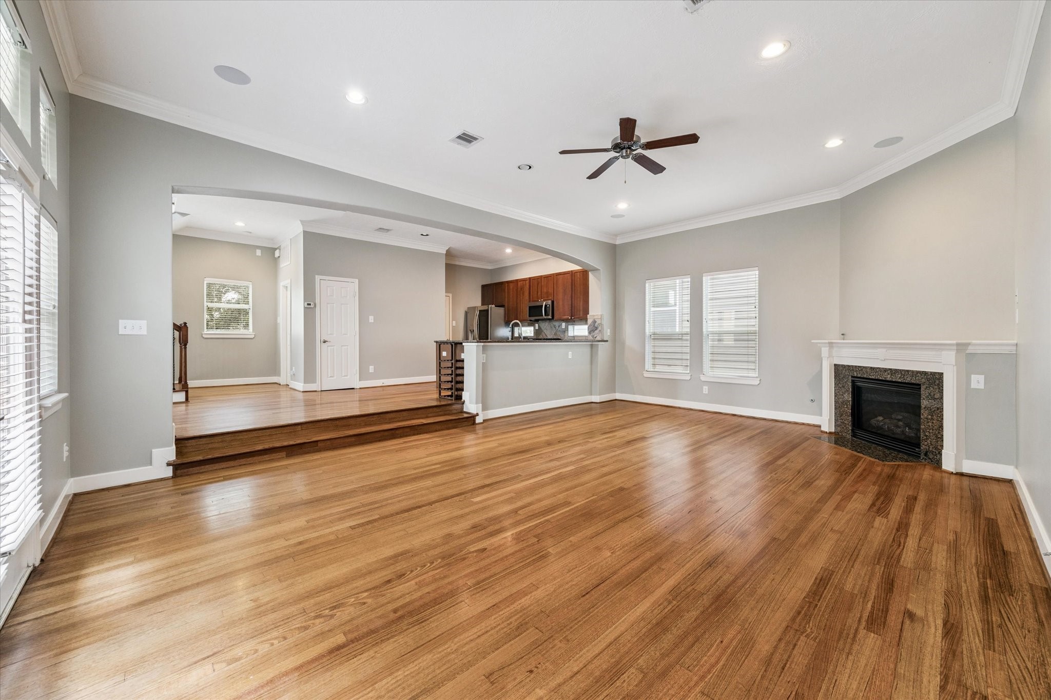 5736 Kansas Street, Unit B Houston, TX 77007 - Photo 15 of 28 an empty room with wooden floor fireplace and windows
