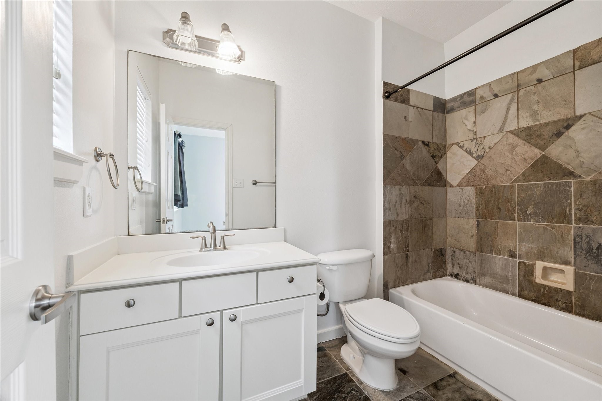 5736 Kansas Street, Unit B Houston, TX 77007 - Photo 26 of 28 a bathroom with a sink toilet vanity and shower