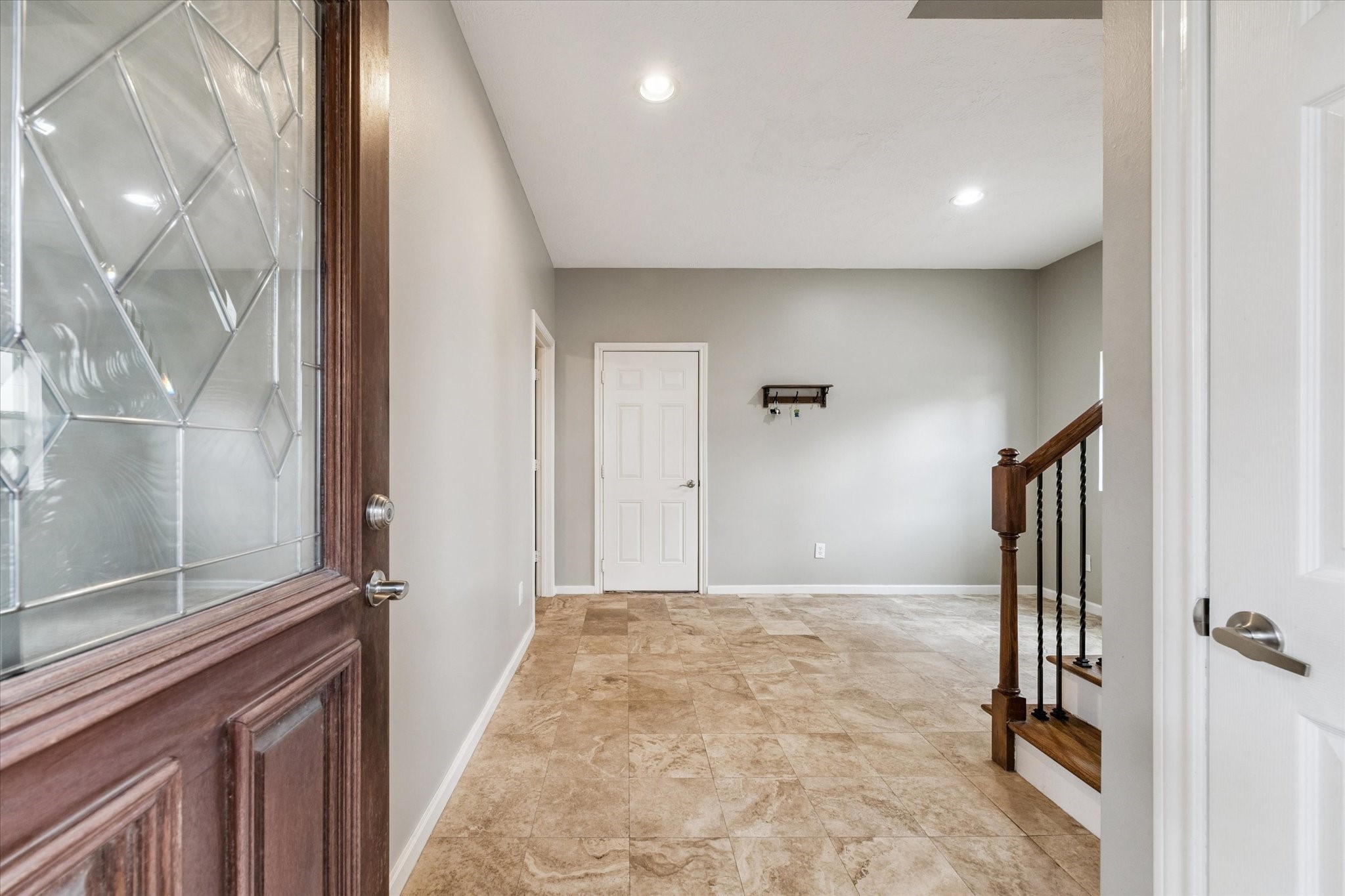 5736 Kansas Street, Unit B Houston, TX 77007 - Photo 5 of 28 a view of a hallway with a glass door and furniture