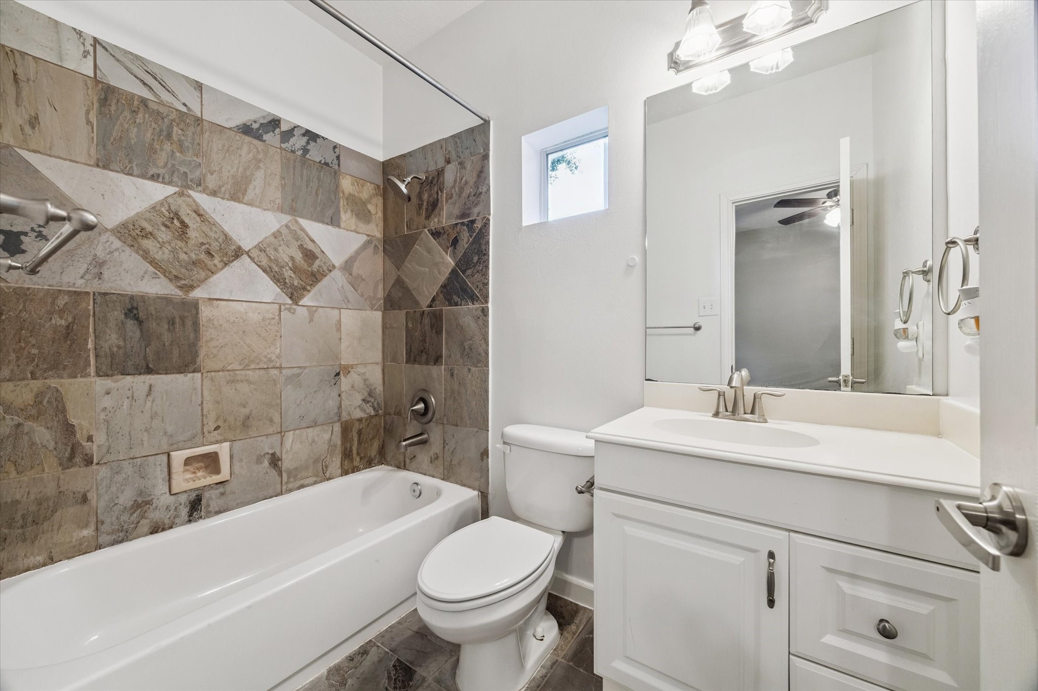 5736 Kansas Street, Unit B Houston, TX 77007 - Photo 8 of 28 a bathroom with a sink toilet vanity and bathtub