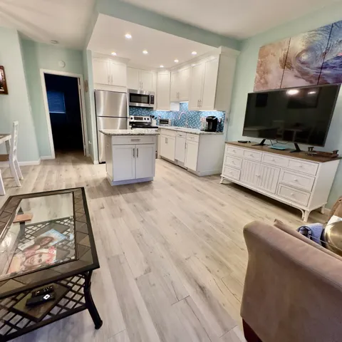 a kitchen with stainless steel appliances kitchen island granite countertop a stove and a sink