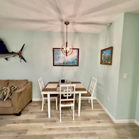 a dining room with furniture a rug and wooden floor