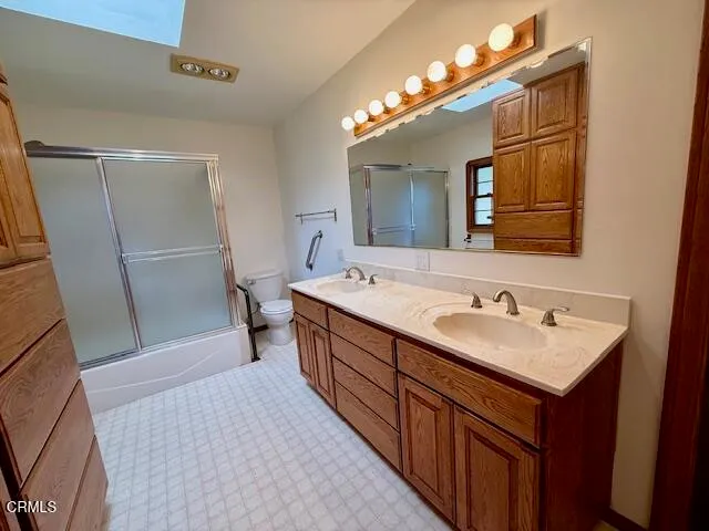 a bathroom with a sink a mirror and a toilet