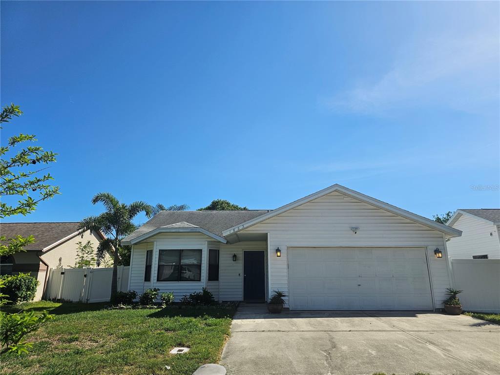 1885 Feather Tree Circle Clearwater, FL 33765 - Photo 1 of 18 a front view of a house with a garden